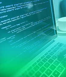 hands writing code on a computer